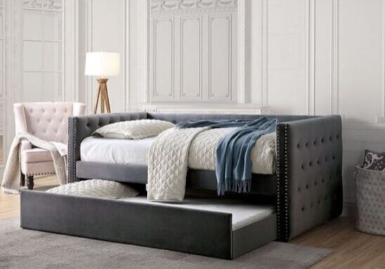 A bed with a trundle in the middle of it