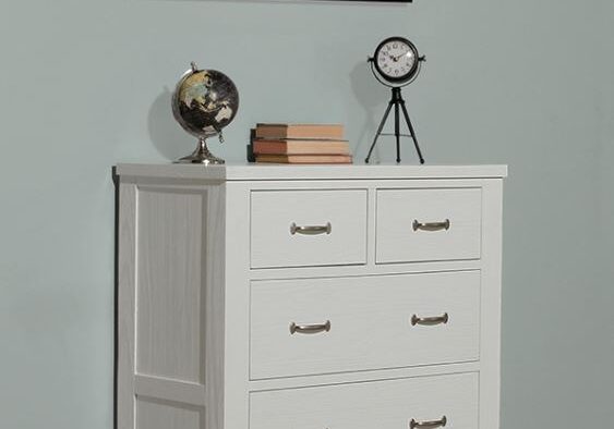 A white dresser with two clocks on top of it.